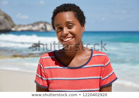 Foto stock: Headshot Of Healthy Positive Female Model Laughs Happily Has Bushy Afro Hair Dressed In White Soft