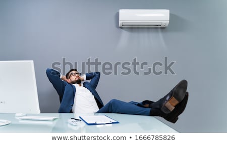Zdjęcia stock: Businessman Enjoying The Cooling Of Air Conditioner