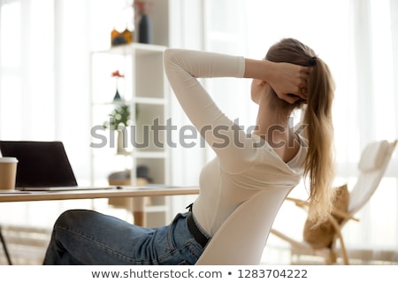 Foto stock: Young Woman Leaning On A Desk