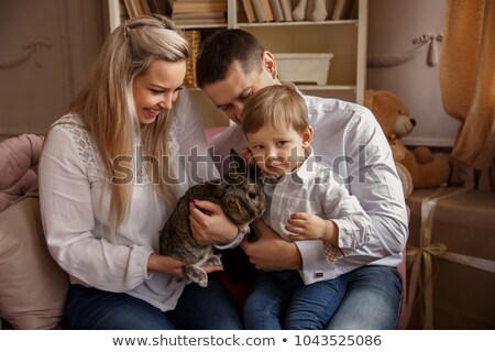 Foto stock: Young Girl Holding A Decorative Bunny