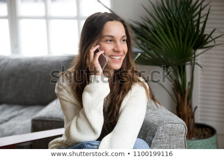 Stock photo: Happy Young Woman Calling By Phone