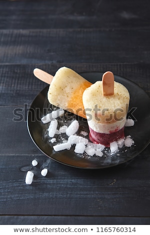 Multicolored Berry Ice Cream On A Stick With Ice Cubes On A Pink Stockfoto © artjazz