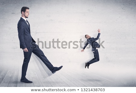 Stok fotoğraf: Big Man Kicking Small Man With Grungy Background