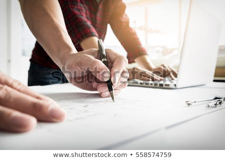 Stok fotoğraf: Close Up Of Persons Engineer Hand Drawing Plan On Blue Print Wi