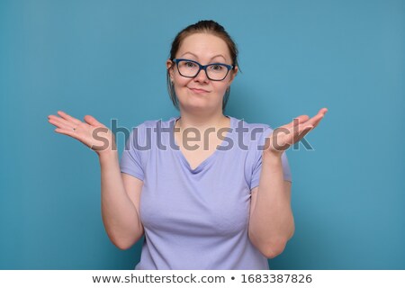 Stockfoto: Young Woman Shrugging Her Shoulders