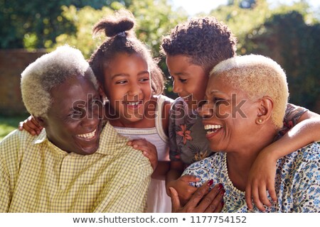 Zdjęcia stock: Front View Of A Happy African American Grandmother Embracing Her Grandchildren While Sitting On Her