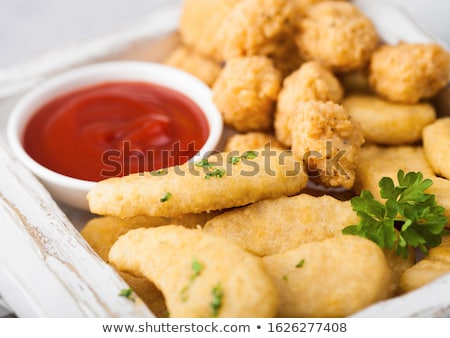 Сток-фото: Buttered Chicken Nuggets And Popcorn Bites In White Vintage Wooden Box With Ketchup And Glass Of Col
