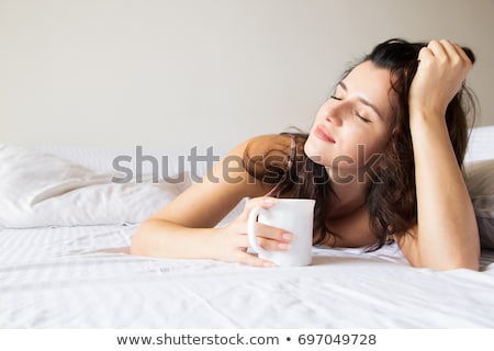 Foto stock: Portrait Of Young Woman Laying In Bed