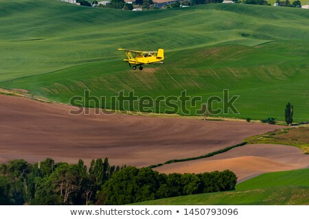 Stock photo: Yellow Airplane Green Wheat Fields Palouse Washington State