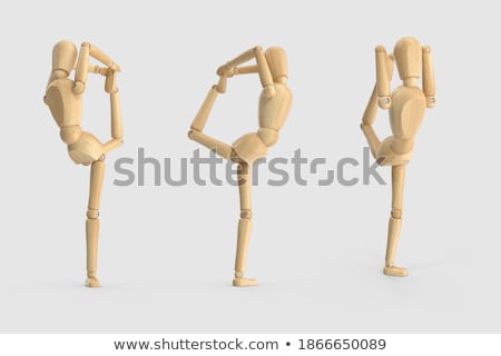 Сток-фото: Wooden Figurine Exercising On Exercise Mat