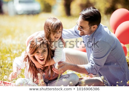 Сток-фото: Laughing Family With Father Mother Daughters Having Picnic At