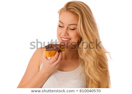 Stockfoto: Woman Spreading Hazelnut Nougat Cream Over Bread Slice