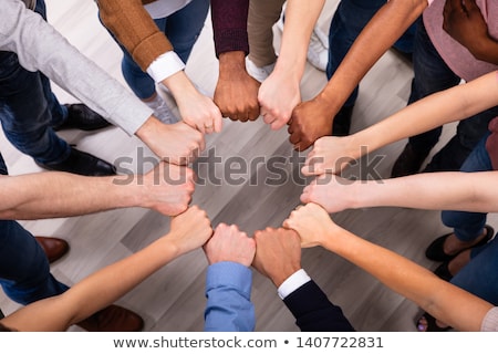 Foto stock: People Hands Joining Their Fist To Form Circle