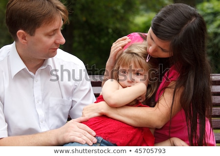 Stock photo: Parents Calm Crying Girl On Walk In Summer Garden Mum Embraces Daughter
