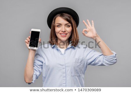 Young Casual Woman Showing Okay Gesture And Promo Of Seasonal Sale 商業照片 © Pressmaster