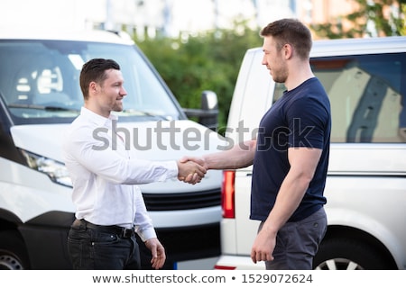 Stockfoto: Smiling Men Shaking Hands In Front Cars Damaged After Accident