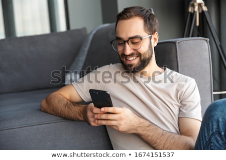 Stock fotó: Casual Man On The Phone From The Floor