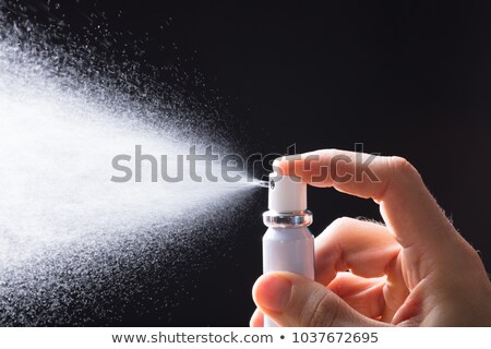 Foto stock: Person Spraying Breath Freshener