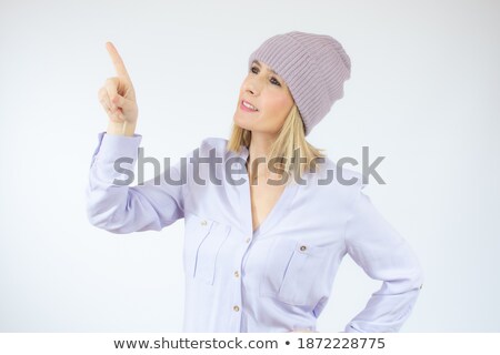 Foto d'archivio: Cute Amazing Young Woman Wearing Winter Hat Posing Isolated Over Blue Wall Background Showing Copysp