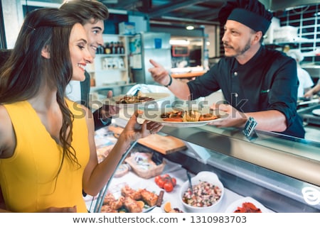 Foto stock: Beautiful Fit Woman Holding A Plate With Shrimps And Vegetables At Restaurant