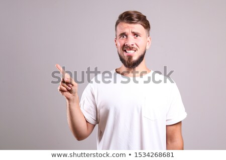 Zdjęcia stock: Portrait Of A Confused Young Man In T Shirt Isolated