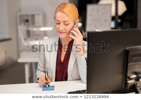 Stok fotoğraf: Businesswoman Calling On Sartphone At Night Office