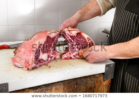 ストックフォト: Mature Butcher With Knife Showing Steak