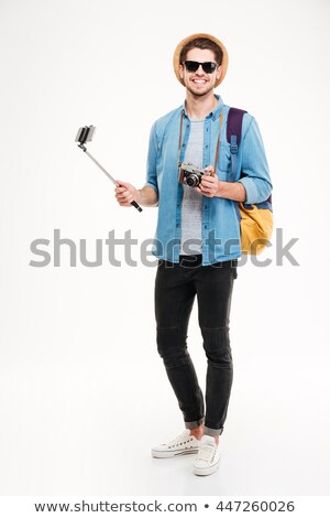 Foto stock: Smiling Man In Sunglasses And Hat Using Old Photo Camera