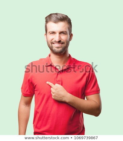 Foto stock: Portrait Of Young Man Wearing Polo Shirt Holding Blank Sign