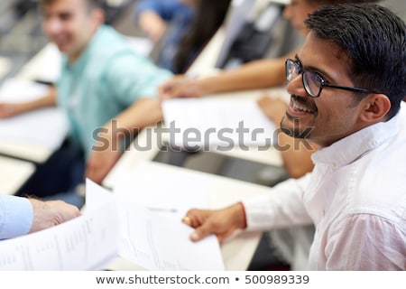 Stok fotoğraf: Happy Student With Exam Test Or Handout At Lecture