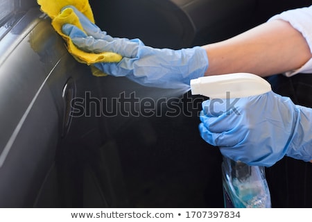 [[stock_photo]]: Cleaning Car Door Handle With Sanitizer Wipe