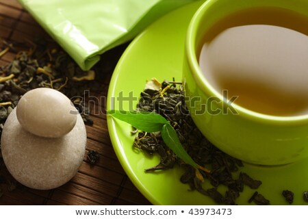 Stok fotoğraf: Close Up Of Loose Green Tea And Cup