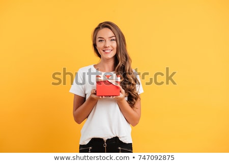 Stock fotó: Smiling Woman Holding Gift Box And Looking At Camera