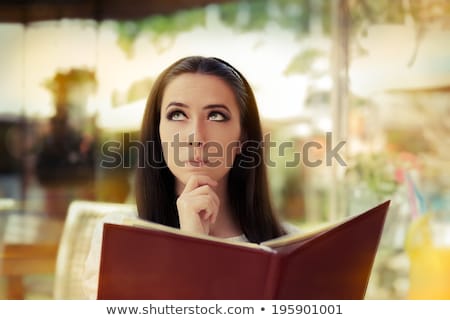 Stock photo: Girl Reading A Menu In A Diner