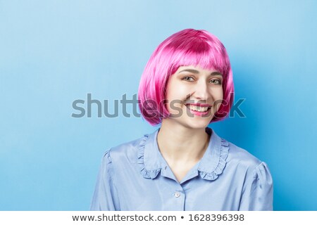 Foto stock: Smiling Woman Wearing Colorful Dress And Blue Wig