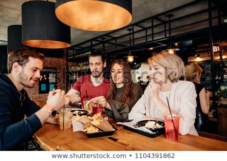 Stock photo: Young Woman Eats French Fries And A Hamburger In The Outside Cafe Beautiful Girl And Junk Food Conc