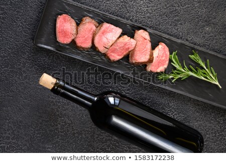 Stok fotoğraf: Bottle Of Wine With Sliced Filet Mignon