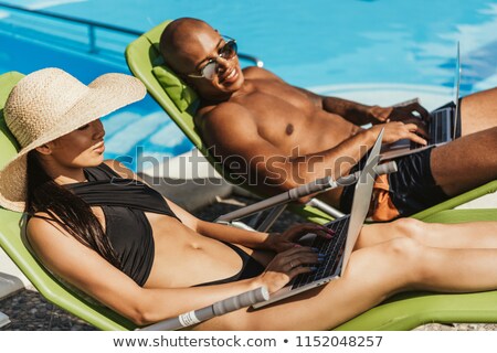 Stock fotó: Couple Relaxing With Laptop In Straw