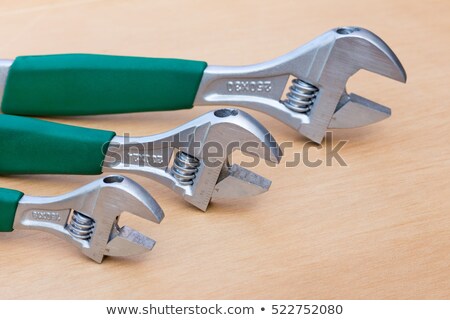 Сток-фото: Three Adjustable Wrenches In Row On Wood