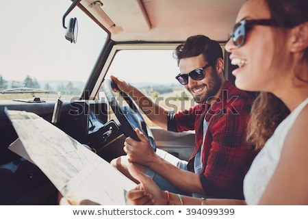 Stock foto: Happy Man And Woman With Road Map Driving In Car