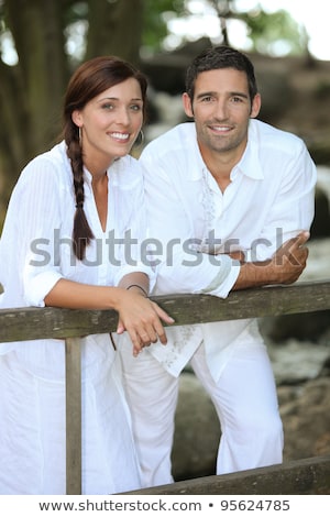 Stockfoto: Couple In White Leaning On A Country Fence