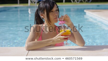 Zdjęcia stock: Pretty Girl Sipping A Tropical Drink In A Pool