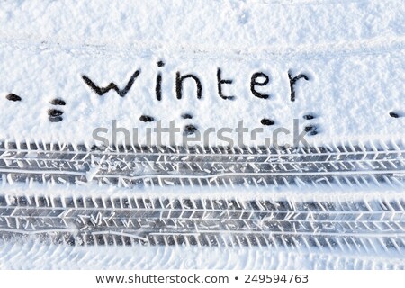 [[stock_photo]]: Word Winter And Tire Tracks In Snow