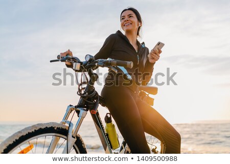 Zdjęcia stock: Woman On Bicycle With Smartphone