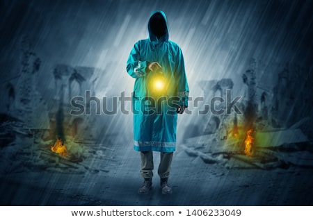 Stok fotoğraf: Man With A Glowing Lantern At A Catastrophe Scene