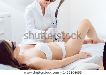 ストックフォト: Hair Removal In Bikini Zone Using A Laser Device On Young Woman