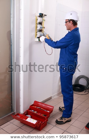 Stockfoto: Electricians Fitting A Fuse Box