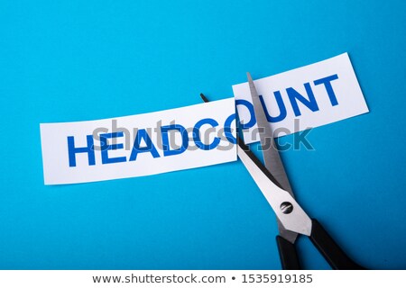 Stock foto: Person Cutting Headcount Using Scissors