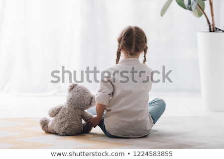 Stok fotoğraf: Little Girl Sitting With Her Teddy Bear