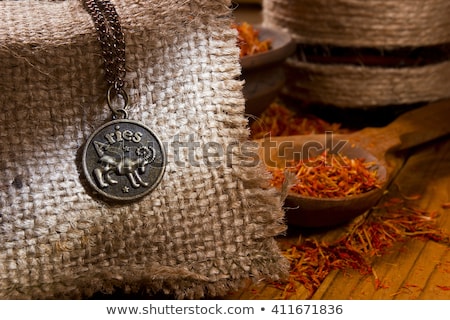 Stockfoto: Medallion With The Sign Of Aries And Saffron